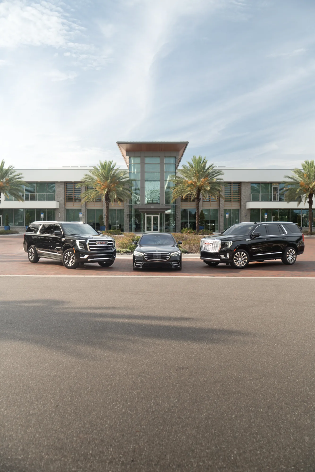 GMC Yukon, Mercedes-Benz S-Class, and GMC Denali lined up for service